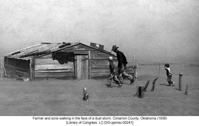 Farmer and sons walking in the face of a dust storm. Cimarron County, Oklahoma (1936) [Library of Congress. LC-DIG-ppmsc-00241]