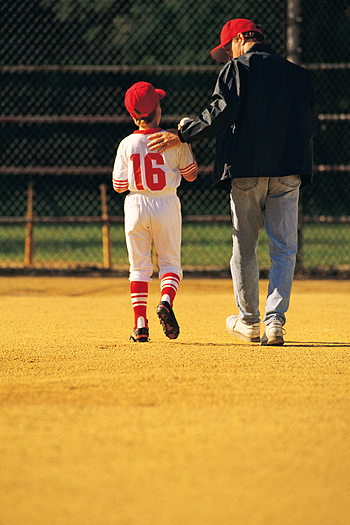 Father with child in a baseball uniform