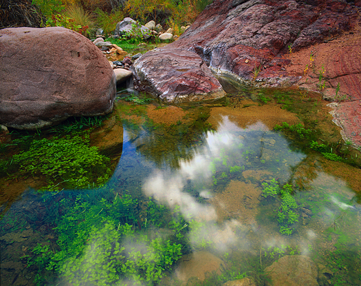 Mountain pool reflecting clouds