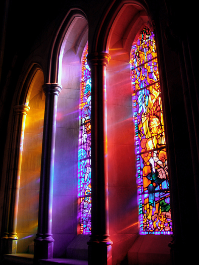 Lights passing through a stained glass window 