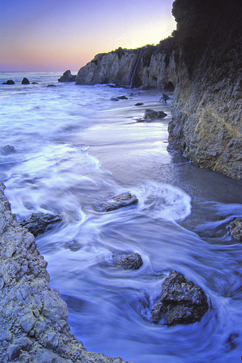 beach sunset boulders and tide at el matador beach near malibu california usa north america
