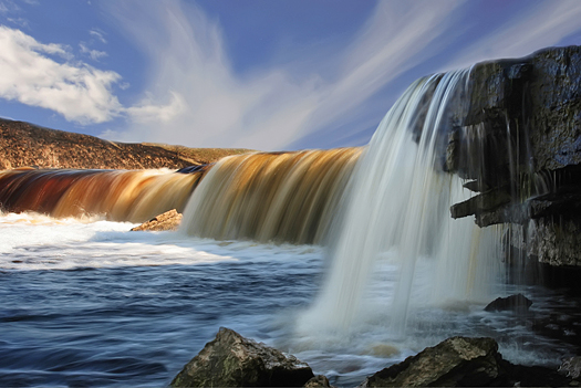 Wide falls with multi-colour water and the spacious sky