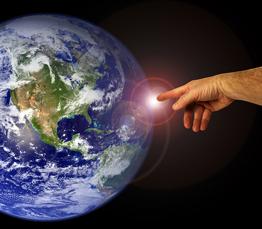 A hand touches the earth. Mankind and peaceful existence