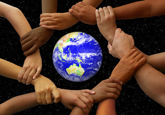 Linked hands framing the earth in a global team theme