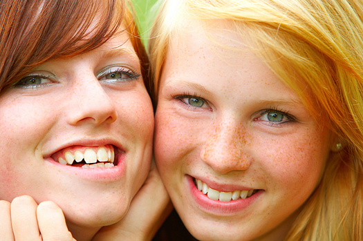 Two smiling young teen girls. Close-up.  