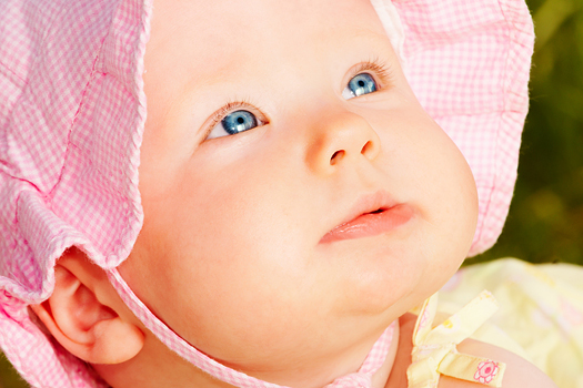 Adorable baby in  pink sunhat