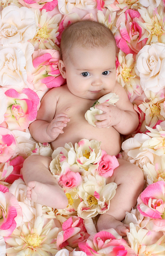 Baby in bed of flowers