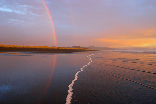 Rainbows on a beach, Taharoa, New Zealand