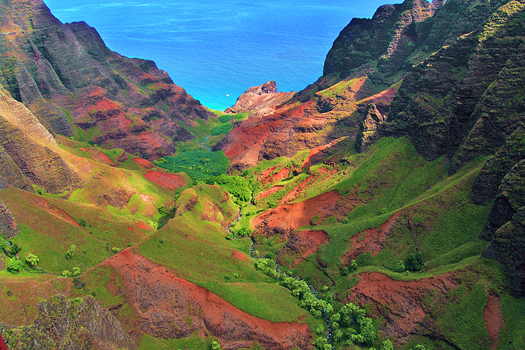 A valley in reds and greens at Kauai Hawaii