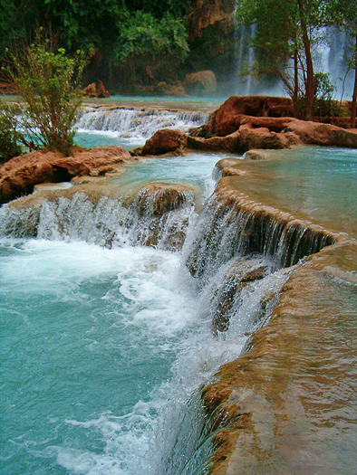 Naturally formed blue pools at waterfall base