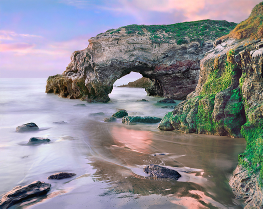 A natural arch along the Pacific coastline.