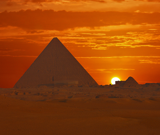 Cheops Sunrise - pyramids against a red sunrise