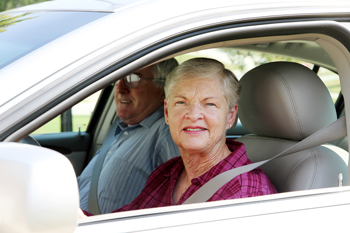 Senior citizen couple sitting in their car